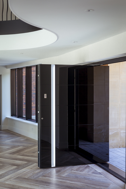 Black glass pivot door with recessed handle